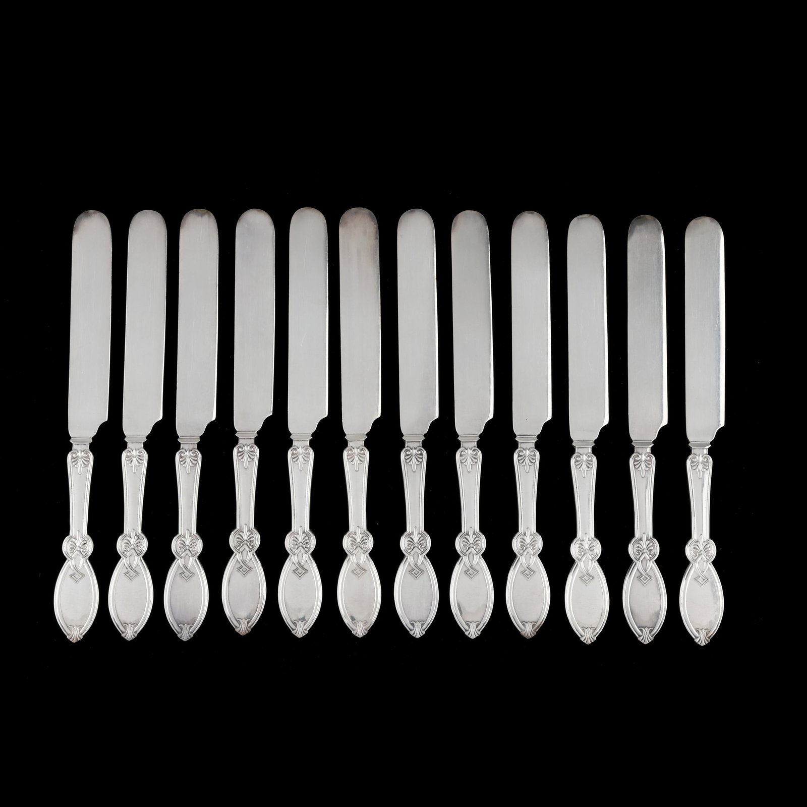 Cased Set of Twelve American Coin Silver Knives: Cased Set of Twelve American Coin Silver Knives circa 1870, mark of R. S. & Co., featuring a stylized handle design and period "ELH" monogram, presented in a fitted retail case. Each 8 1/8 in.; Case d