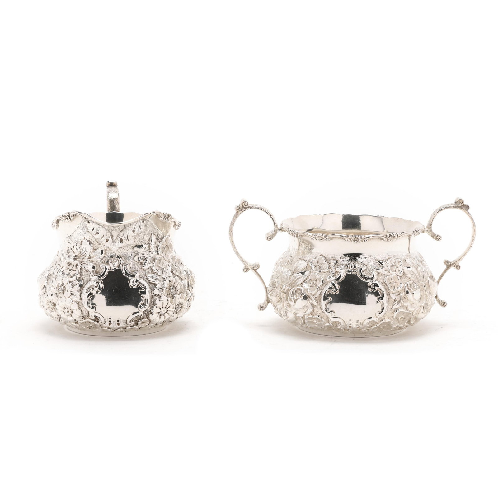 Repousse Sterling Silver Creamer and Sugar by A. G. Schultz & Co.: Repousse Sterling Silver Creamer and Sugar by A. G. Schultz & Co. Baltimore, first half of the 20th century, with allover hand-chased floral decoration against a stippled ground, featuring central
