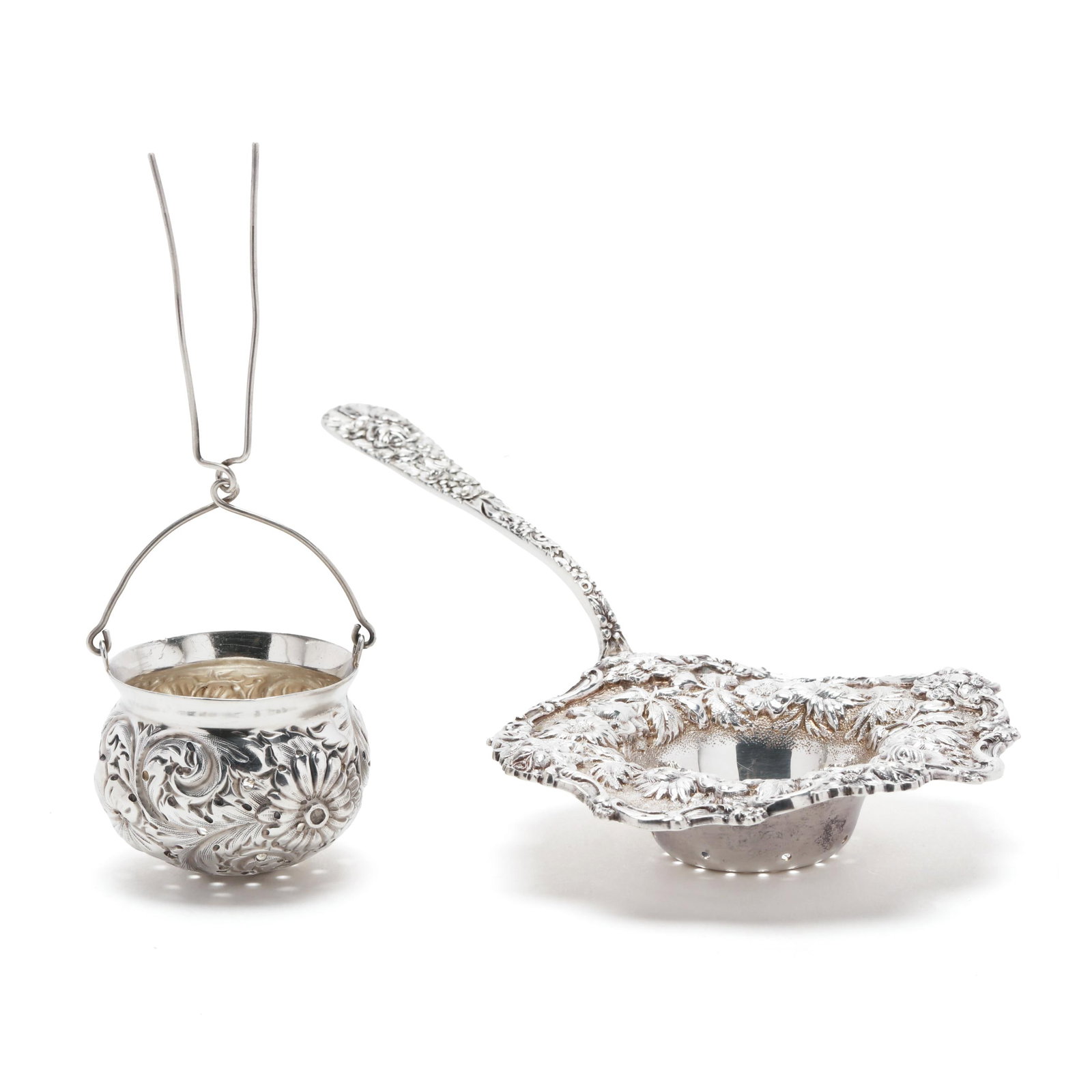 Sterling Silver Repousse Sugar Sifter & Tea Ball: Sterling Silver Repousse Sugar Sifter & Tea Ball the sugar sifter, mark of The Stieff Co., Baltimore, circa 1930s-1940s, featuring hand-chased floral decoration to the flange and a scrolled rim, perio