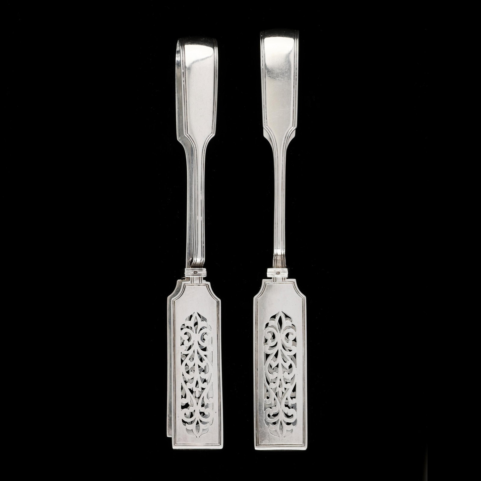 Two Pairs of Victorian Silver Sandwich Tongs, Mark of Chawner & Co (George William Adams): Two Pairs of Victorian Silver Sandwich Tongs, Mark of Chawner & Co (George William Adams) London (1864), featuring reticulated tong blades and a threaded edge, armorial thistle monograms to the end. E