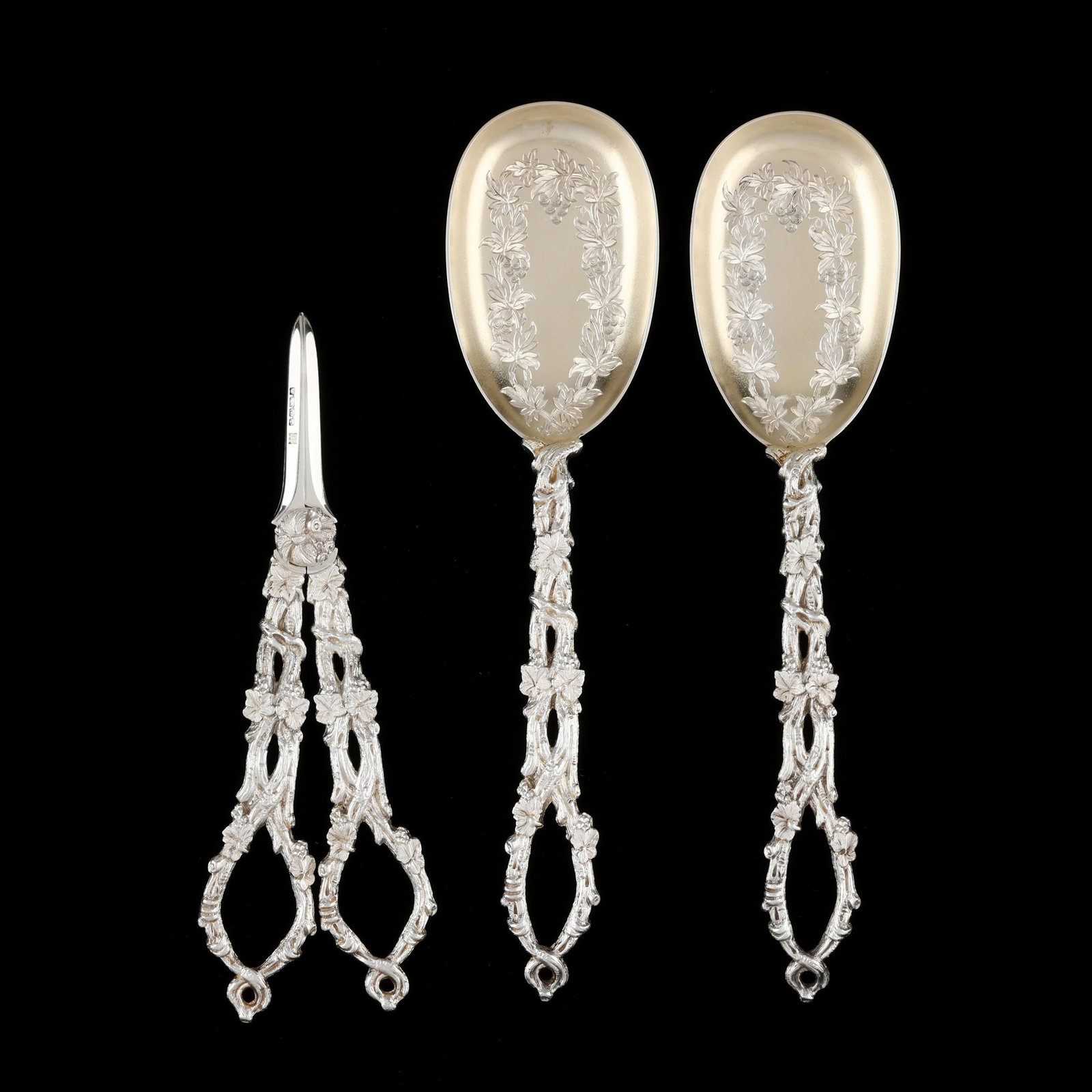 Victorian Silver Serving Spoon and Grape Shearer Set, Mark of William Hutton & Sons: Victorian Silver Serving Spoon and Grape Shearer Set, Mark of William Hutton & Sons Sheffield (1879); with chased vine decoration to the handles, the spoons with gold wash bowls and conforming engrave