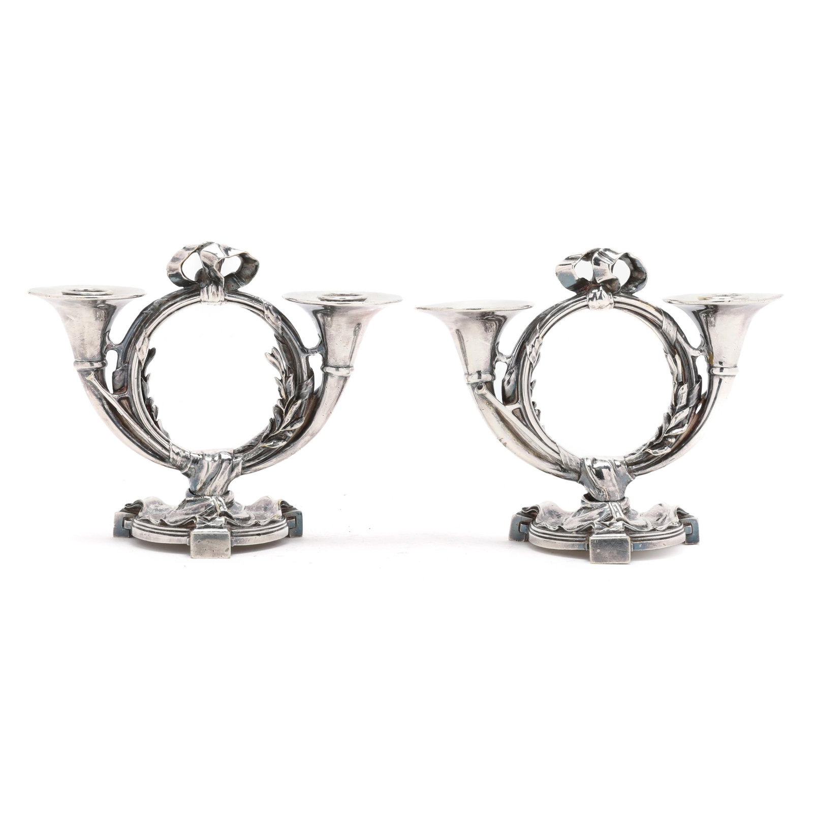 Pair of Silver-Plated Candelabra with Horn and Ribbon Motifs: Pair of Silver-Plated Candelabra with Horn and Ribbon Motifs late 19th century, possibly French, each a weighted two-light form with double horn motif, ribbon, and laurels, not marked or monogrammed.