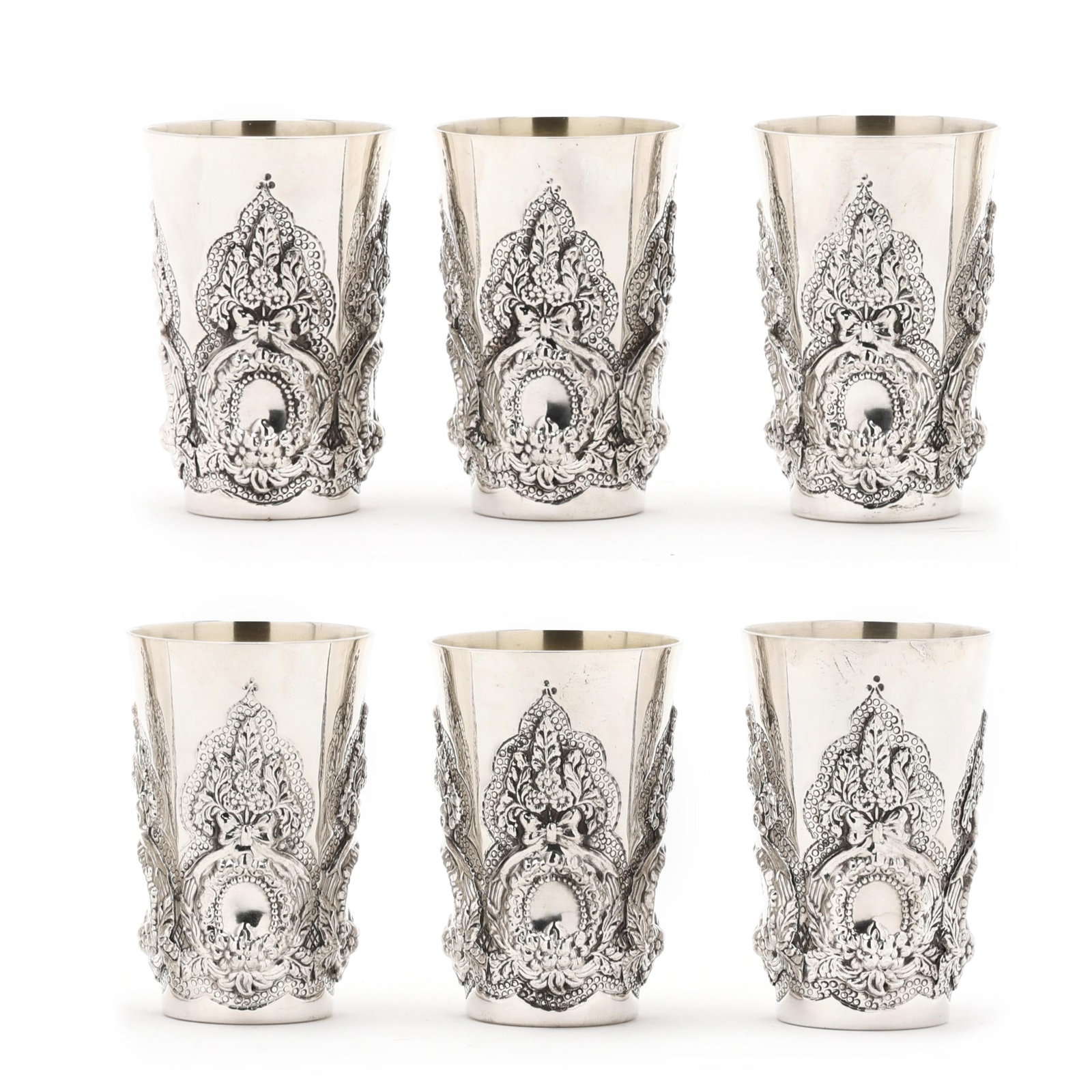 Set of Six Israeli Silver Kiddush Cups, Mark of Hadad Bros.: Set of Six Israeli Silver Kiddush Cups, Mark of Hadad Bros. mid-20th century, .925 silver, with wreath repousse decoration to the bodies, gold wash interior. Each 4 x 2 1/2 in. dia. 35 total troy oz.