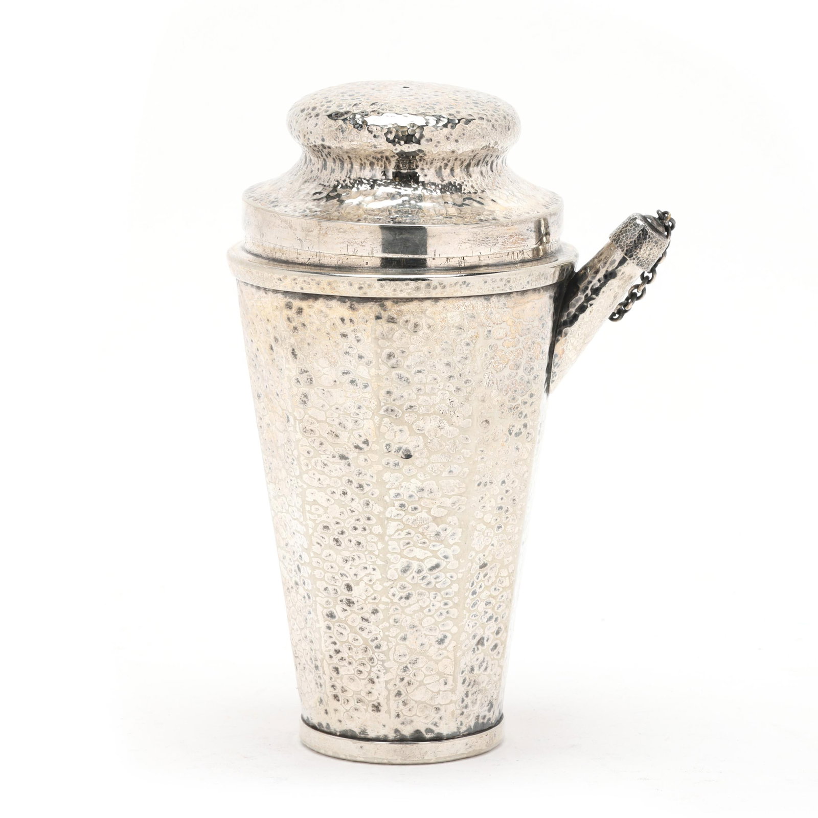 Joseph Heinrichs Silver-Plated Cocktail Shaker: Joseph Heinrichs Silver-Plated Cocktail Shaker New York, circa 1910, with an allover hammered surface, featuring a cover and chain cap stopper, not monogrammed. 8 3/4 x 6 1/4 x 5 in. Additional high-r