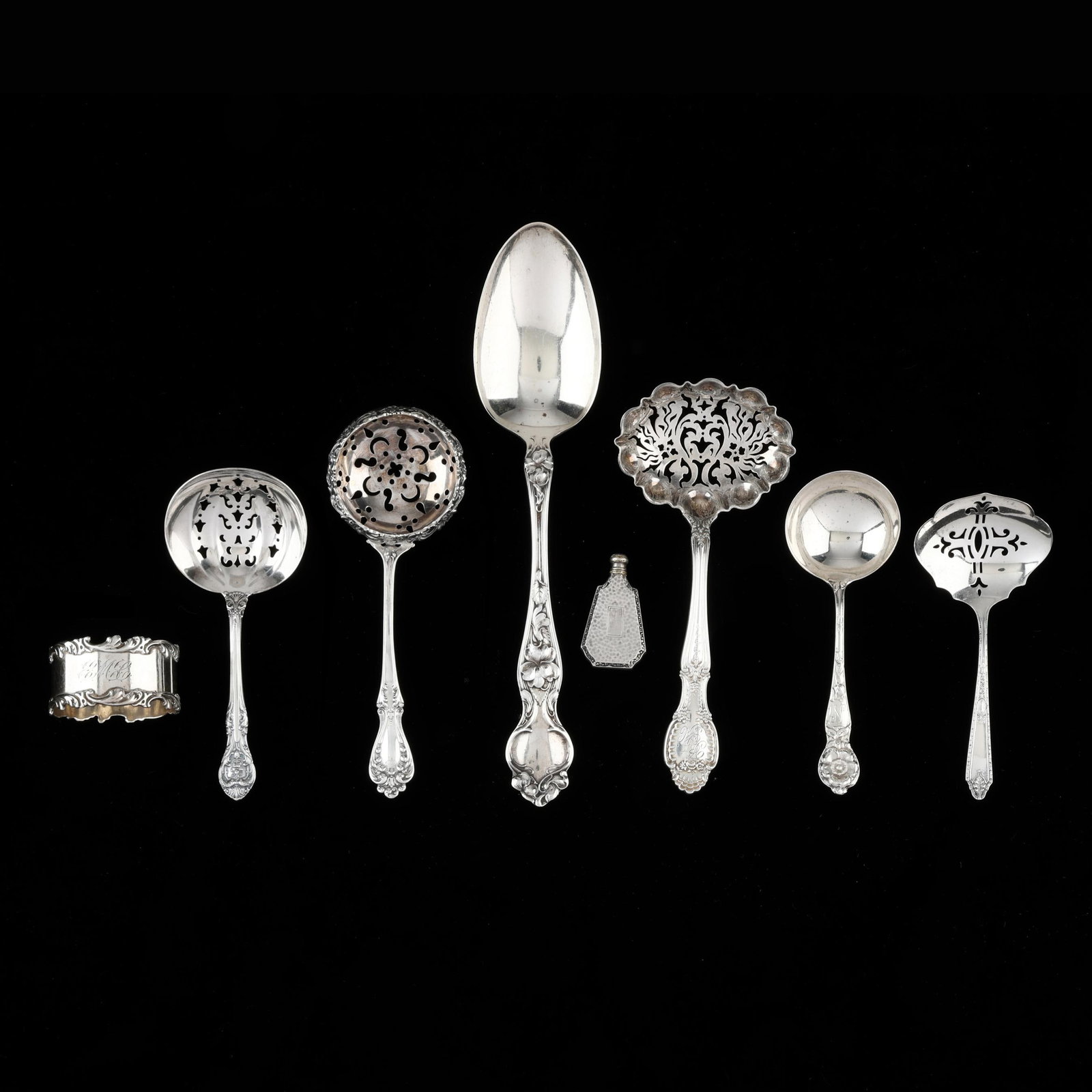 Eight Pieces of Sterling Silver Tableware and Accessories: Eight Pieces of Sterling Silver Tableware and Accessories includes a Wallace Violate Tablespoon; a Watson Wild Rose bon bon spoon; a Tiffany Richelieu sifter; a Gorham Kind Edward bon bon spoon; a
