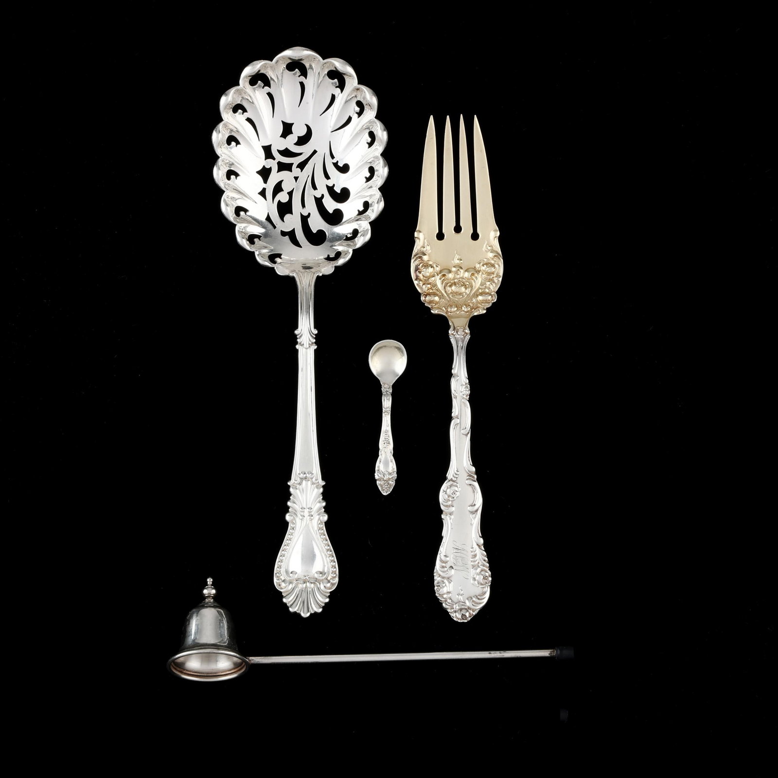 Four Assorted Sterling Silver Flatware Servers: Four Assorted Sterling Silver Flatware Servers includes a Watson Bead pierced shell serving spoon; a Towle Old English meat fork with gold wash tines, a Gorham sterling candle snuffer; and a sterling 