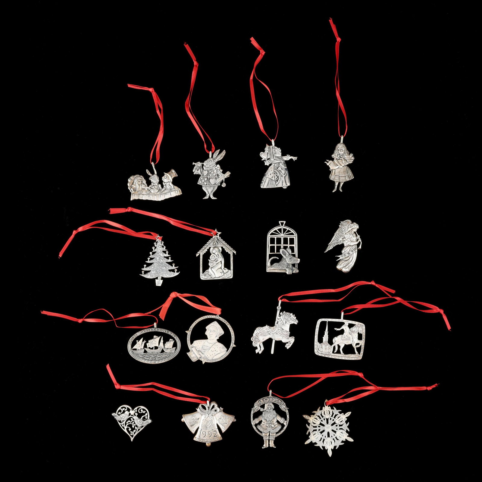 Sixteen Hand & Hammer Sterling Silver Christmas Ornaments: Sixteen Hand & Hammer Sterling Silver Christmas Ornaments late 20th and early 21st century, including (4) with an Alice & Wonderland theme, (2) with a Christopher Columbus theme; and various holiday