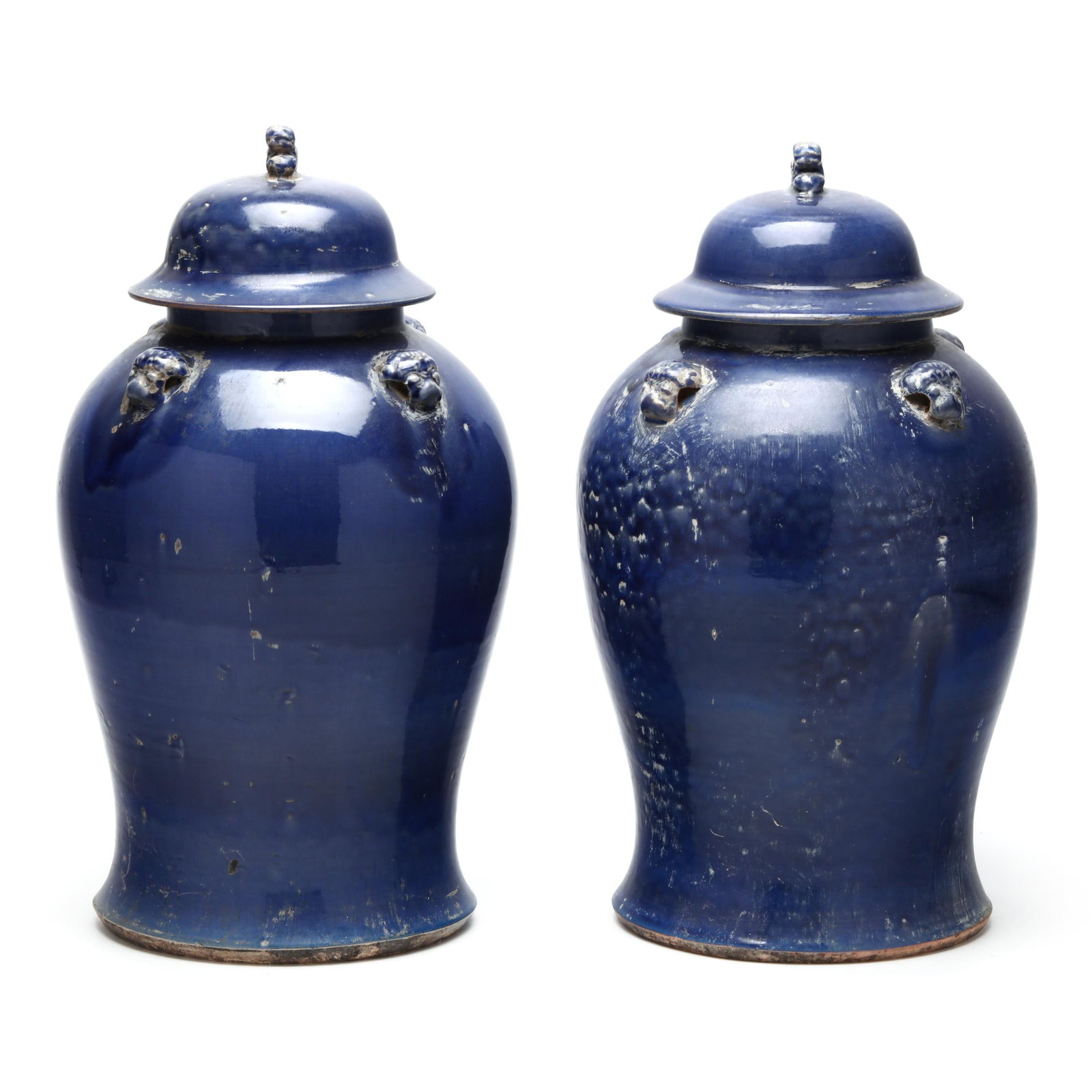 A Pair of Large Chinese Cobalt Blue Glazed Temple Jars: A Pair of Large Chinese Cobalt Blue Glazed Temple Jars late 20th century, each featuring four applied lion mask mounts to shoulders, each domed cover with foo dog finial. Each 19 in., 11 1/2 in. diame