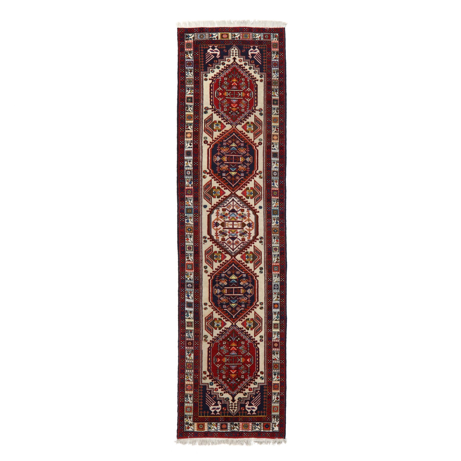 Indo-Persian Runner: Indo-Persian Runner wool on cotton foundation, the five hexagonal medallions filled with geometric motifs, on a cream field, the black spandrels with peacock motifs, the cream border with stylized