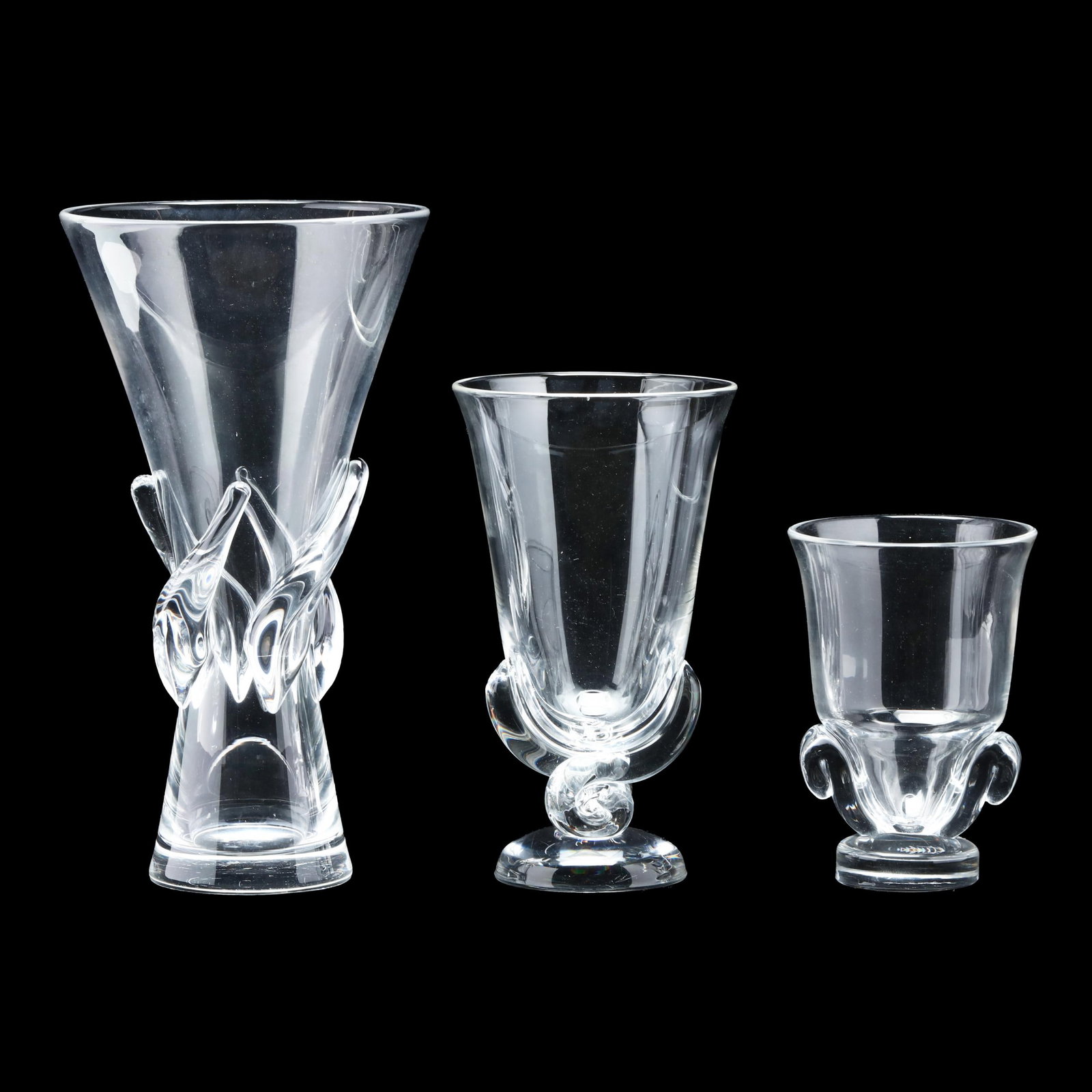 Steuben, Three Clear Glass Vases: Steuben, Three Clear Glass Vases mid-century, including: flower vase no. 7964, featuring scroll sides (6 x 4.25 in.); flower vase no. 7913, (8.5 x 4.9 in.); rose vase no. 8090 (11.25 x 6.5 in.); each