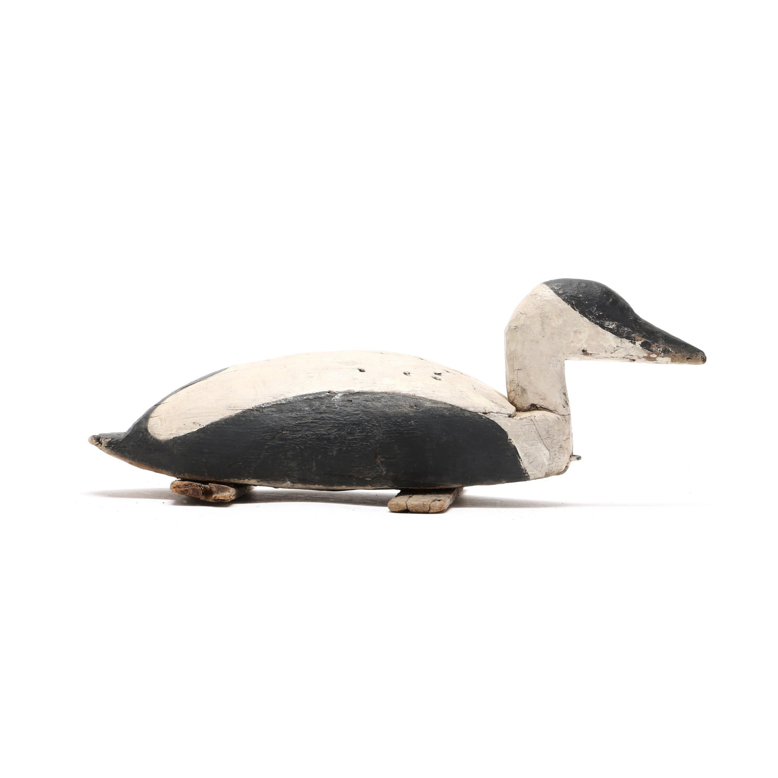 Early Eider: Early Eider Probably New England, circa 1910, carved and painted wood, two wood slats mailed to the bottom. Length 15 in. x 5.5 x 10 From a Private Collection donated to benefit the conservation