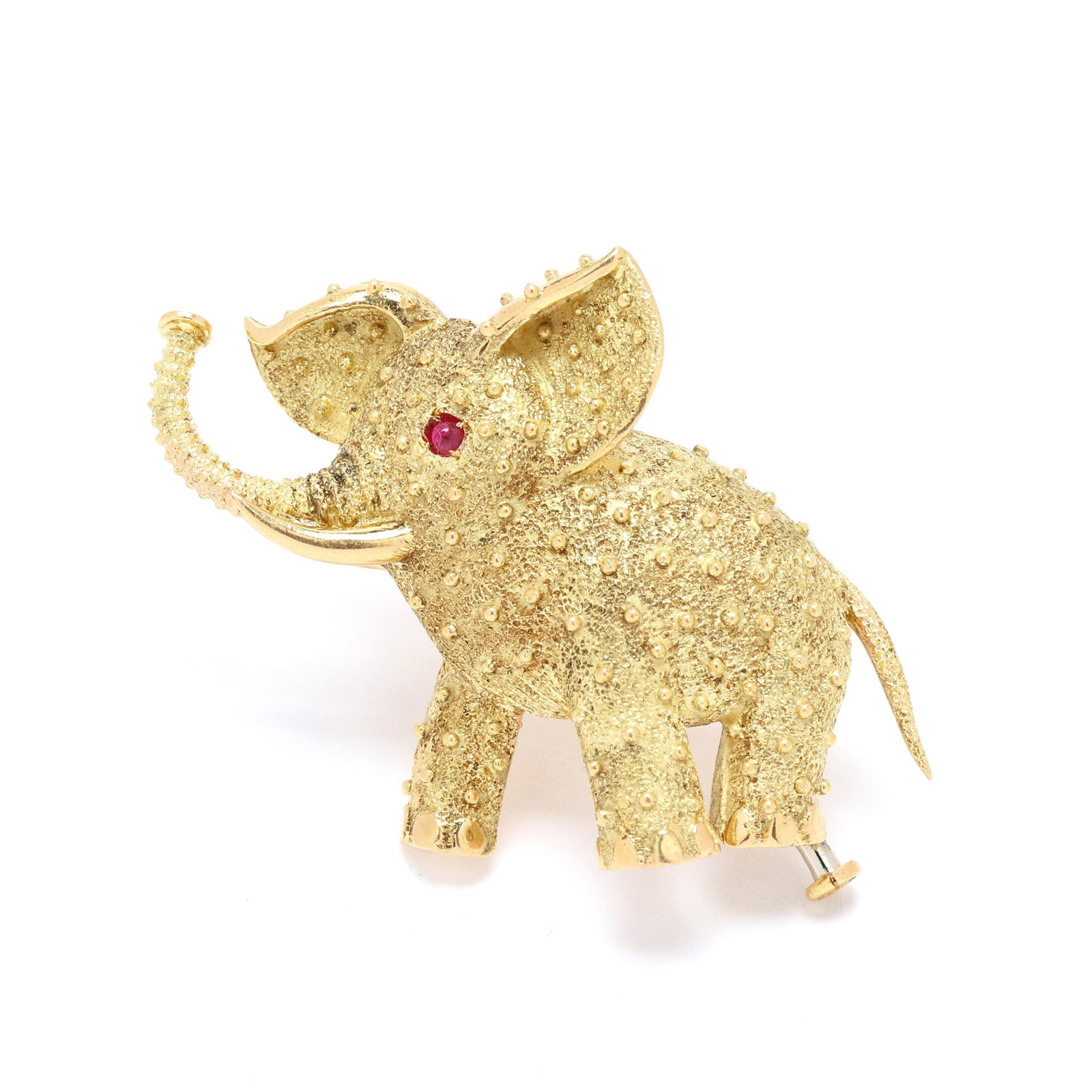 Vintage Gold and Ruby Elephant Motif Brooch, Cartier: Vintage Gold and Ruby Elephant Motif Brooch, Cartier finely textured and bead decorated gold figure of an elephant with raised trunk, set with a round cabochon cut ruby eye, completed with a double lo