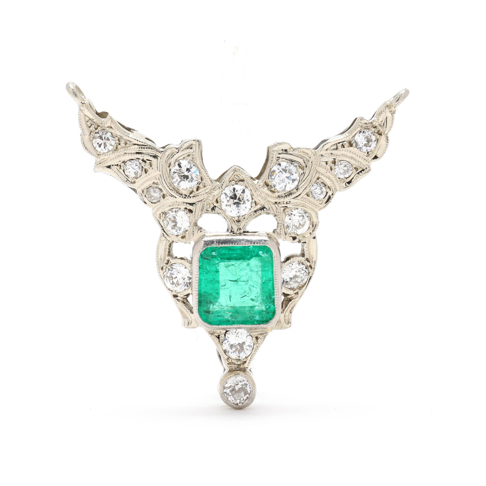 Vintage White Gold, Emerald, and Diamond Brooch: Vintage White Gold, Emerald, and Diamond Brooch in a winged motif, bezel set to the center with a square cut emerald (7.0 x 7.0mm) weighing approximately 1.62 carats, with milgrain detailing and set t