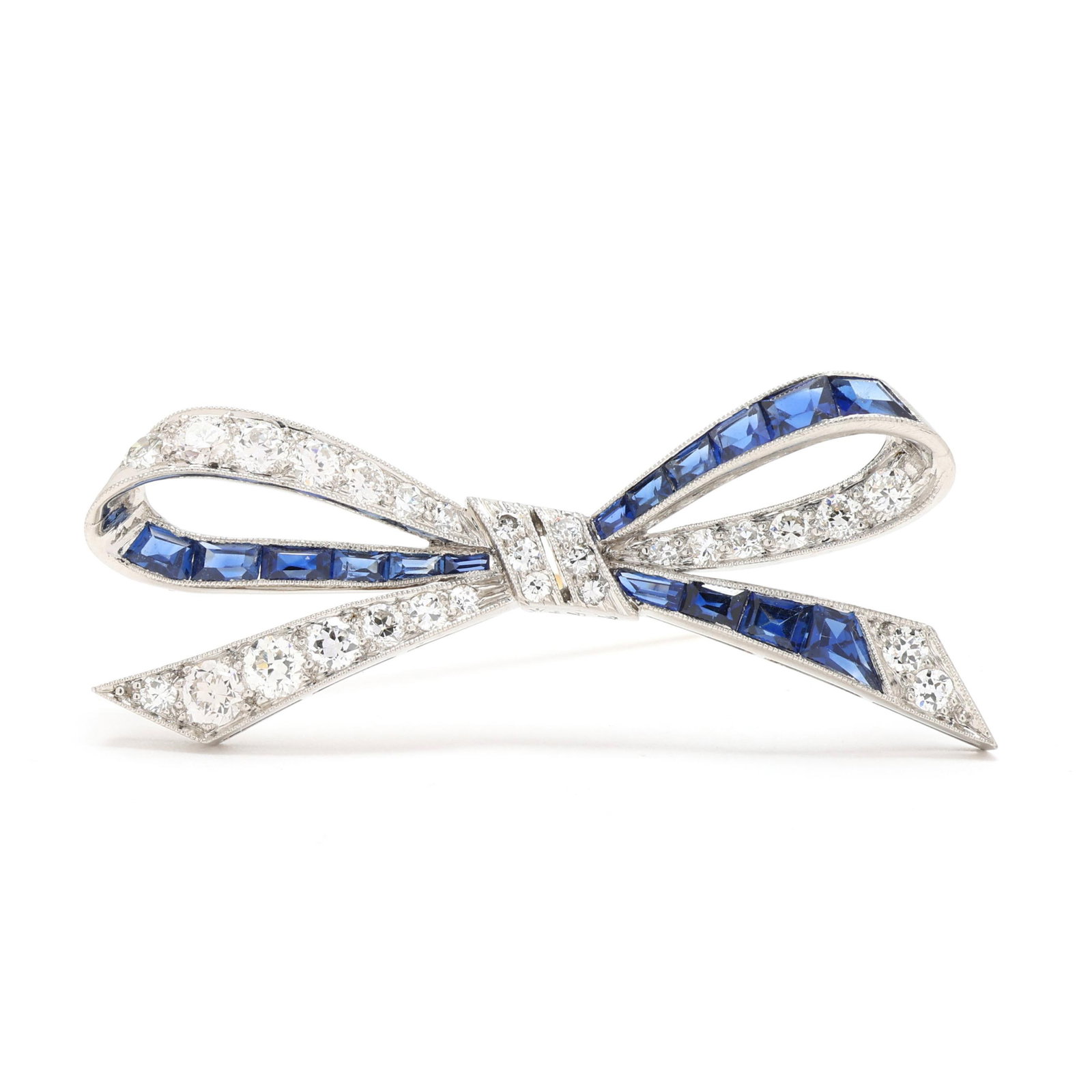 Vintage Platinum, Diamond, and Sapphire Bow Motif Brooch, Tiffany & Co.: Vintage Platinum, Diamond, and Sapphire Bow Motif Brooch, Tiffany & Co. in a ribbon bow design set with transitional cut diamonds weighing approximately 1.20 total carats (G-H color, VS2-SI1 clarity),
