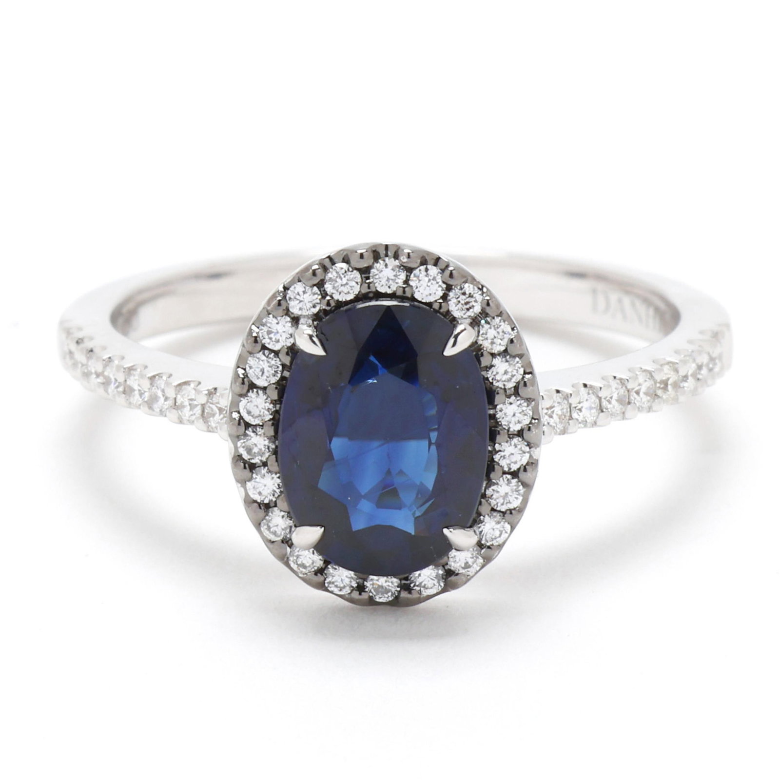 White Gold, Sapphire, and Diamond Ring, Christophe Danhier: White Gold, Sapphire, and Diamond Ring, Christophe Danhier centered on an oval cut sapphire (8.0 x 6.0mm) weighing approximately 1.60 carats, the halo and shoulders set with full cut round diamonds we