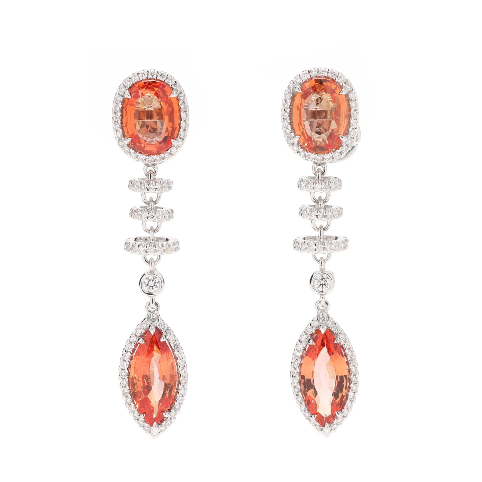 White Gold, Orange Sapphire, and Diamond Drop Earrings: White Gold, Orange Sapphire, and Diamond Drop Earrings each with a prong set oval cut orange sapphire surmount (8.9 x 6.7 x 3.5mm; 9.0 x 6.6 x 3.0mm) weighing approximately 3.25 total carats suspendin