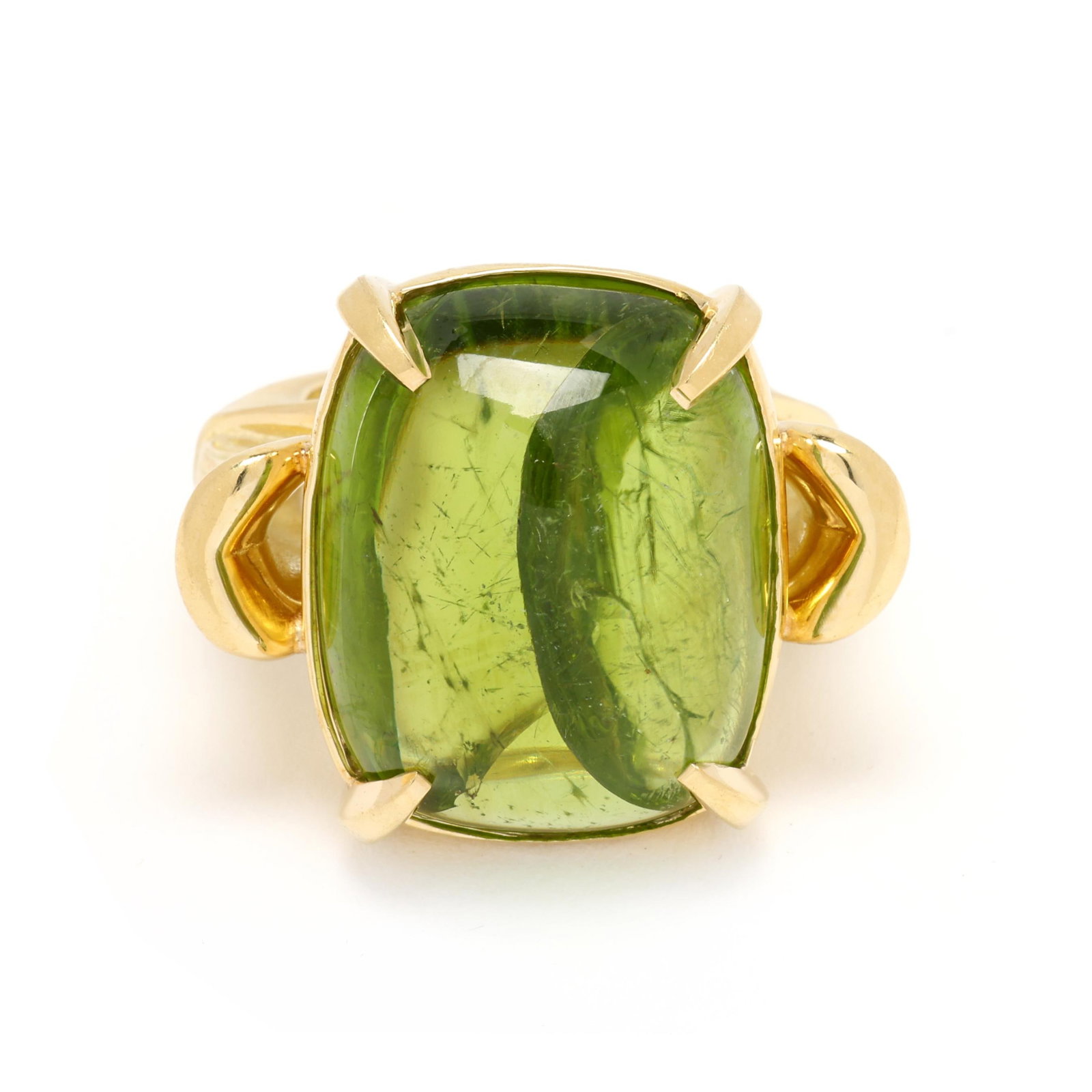 Gold and Peridot Ring: Gold and Peridot Ring centered on a rectangular cabochon cut peridot (21.8 x 17.4 x 9.1mm) weighing approximately 30.0 carats, the shoulders in a fluted flower motif, on a brushed gold tapered shank,