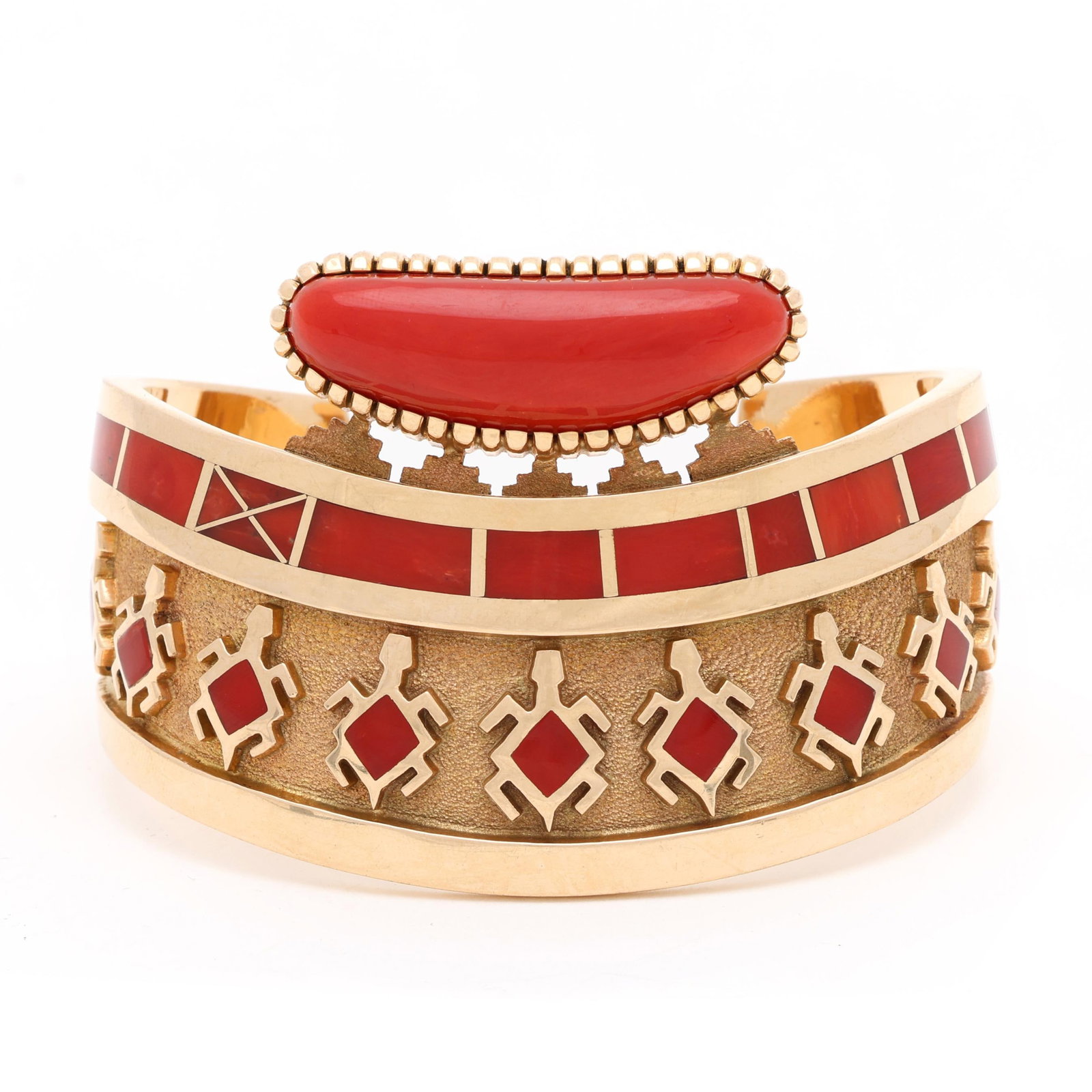 Gold and Coral Cuff Bracelet, Vernon Haskie: Gold and Coral Cuff Bracelet, Vernon Haskie the shaped wide cuff bracelet with an oblong coral cabochon cut surmount, the cuff inlaid with coral in repeating geometric and turtle motifs, stamped 14K