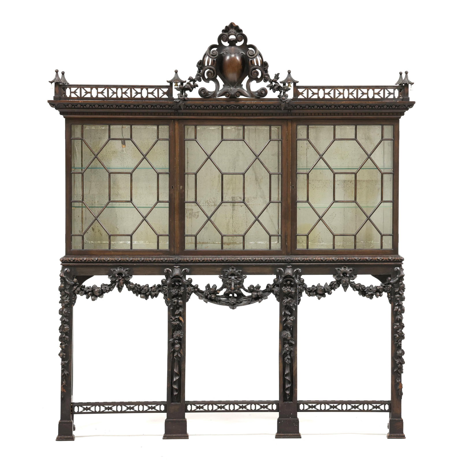 Chinese Chippendale Style Carved Mahogany Cabinet on Stand: Chinese Chippendale Style Carved Mahogany Cabinet on Stand circa 1900, two part form, upper pagoda form cabinet with relief carved and pierced fretwork cornice featuring turned drop bells, three hinge