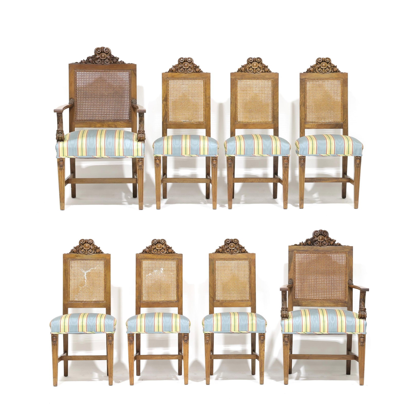 Set of Eight Renaissance Revival Carved Circassian Walnut Dining Chairs: Set of Eight Renaissance Revival Carved Circassian Walnut Dining Chairs early 20th century, including two armchairs and six side chairs, all with relief carved cartouche at crest rails, cane back, str