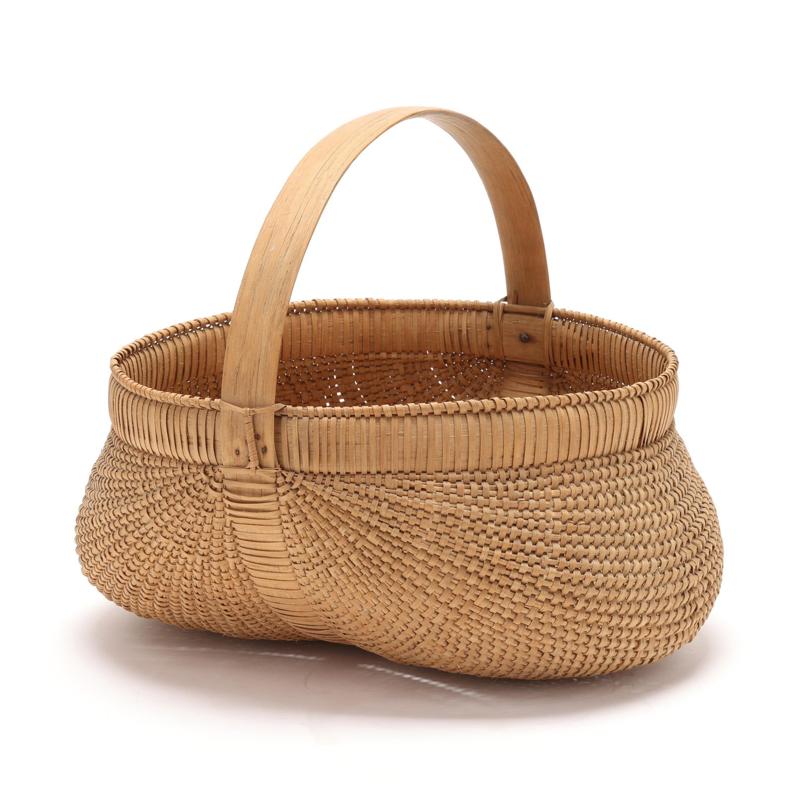 Mary Causby (Burke County, NC, 1873-1955), Fine Rib-Type Buttocks Basket: Mary Causby (Burke County, NC, 1873-1955), Fine Rib-Type Buttocks Basket crafted of finely woven white oak splints in a double lobed shape with bentwood handle, wrapped upper and lower rims, distincti