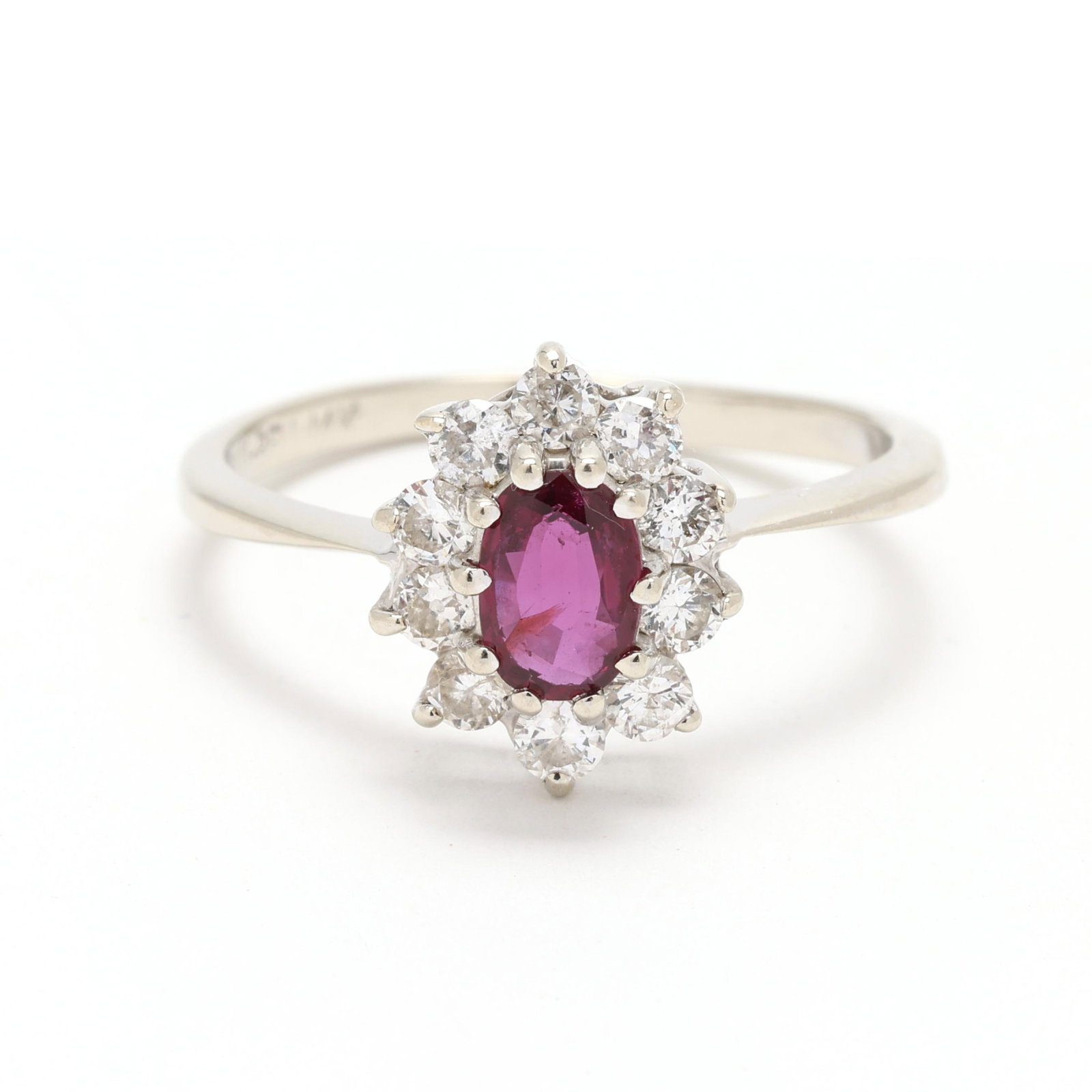 White Gold, Ruby, and Diamond Ring: White Gold, Ruby, and Diamond Ring centered on an oval cut ruby (5.5 x 3.8 x 2.06mm) weighing approximately .33 carat, set within a halo of full cut round diamonds weighing approximately .30 total