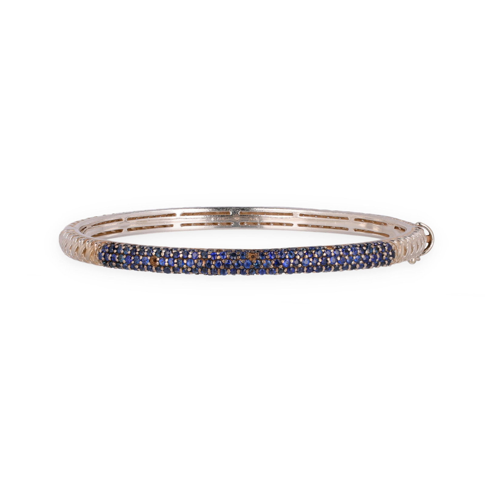 Silver and Sapphire Bangle Bracelet, Slane: Silver and Sapphire Bangle Bracelet, Slane in a hinged design, pavé set to one half with round cut sapphires (1.5mm), with openwork woven motif to other half, completed with a box clasp and figure-ei