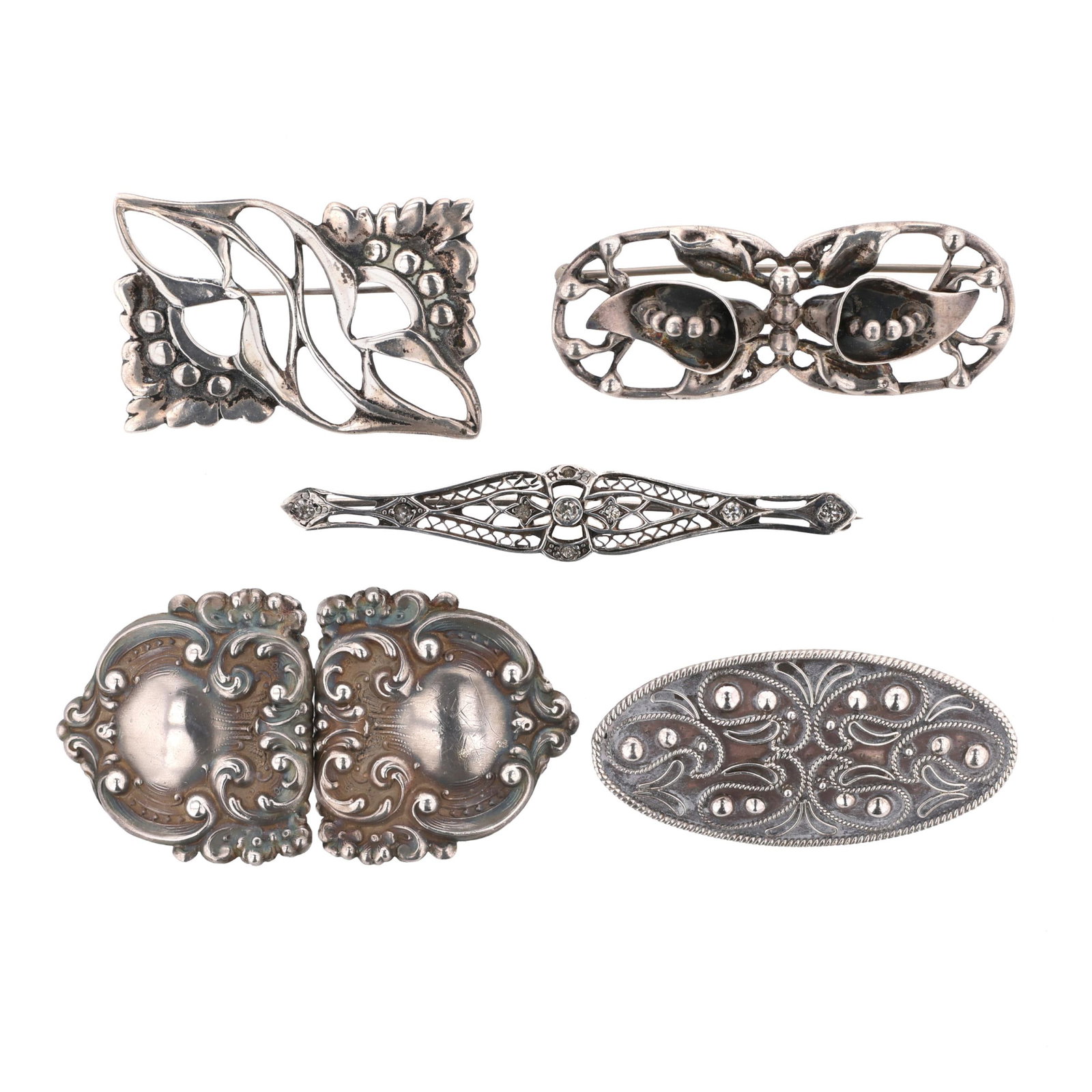 Group of Five Silver Brooches and A Silver Buckle: Group of Five Silver Brooches and A Silver Buckle to include: a brooch in a double oval openwork design, with raised calla lily and foliate motifs, completed with a locking pin stem, stamped Sterling