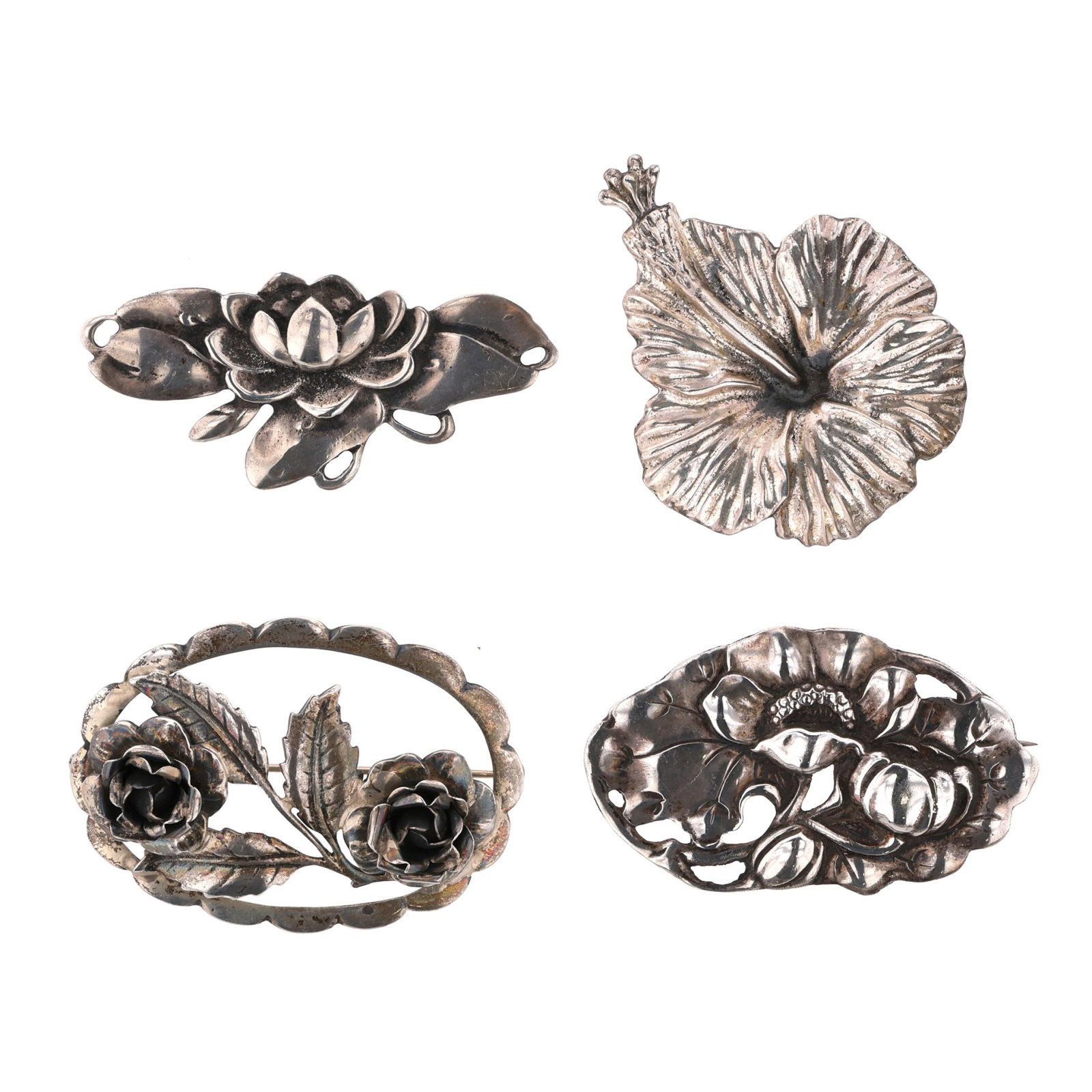 Group of Four Silver Floral Motif Brooches: Group of Four Silver Floral Motif Brooches to include: a brooch in an openwork design, depicting two blooming roses, with stem and foliate detail, and with scalloped border, completed with a locking