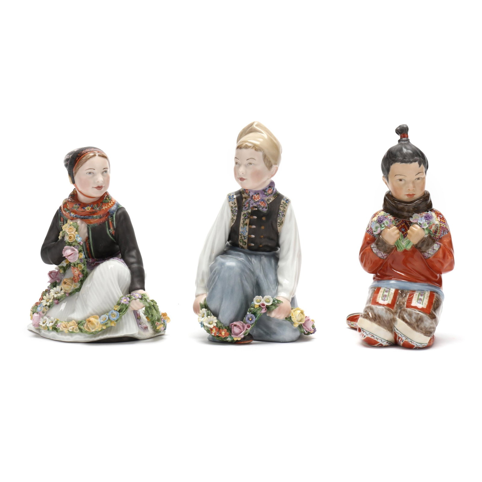 Royal Copenhagen, A Group of Three Greenland Children: Royal Copenhagen, A Group of Three Greenland Children Denmark, circa 1920s, hand-painted porcelain, designed by Carl Martin-Hansen, with company marks and impressed marks to the underside, each modele