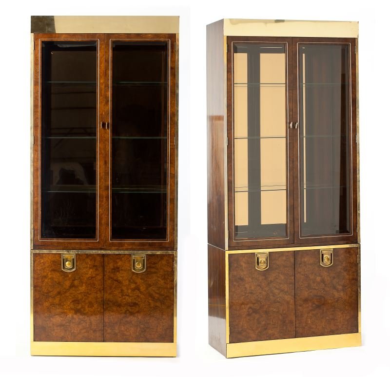 Bernhard Rohne, Pair of Cabinets: Bernhard Rohne, Pair of Cabinets(American, 20th century), for Mastercraft, burl wood veneers with brass ornaments, two glass doors open to a lighted interior of three glass shelves with a gold-toned m