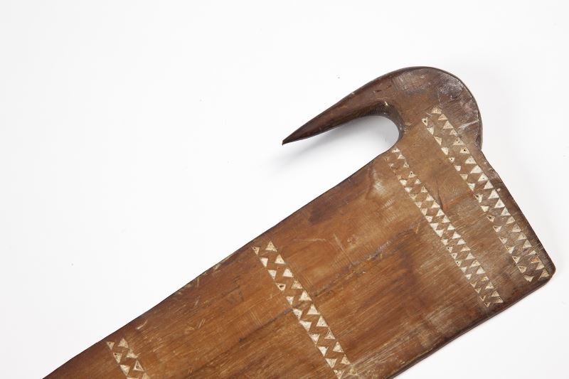 Polynesian Paddle Club: Polynesian Paddle Club early 20th century, the hooked blade incised with registers of opposing triangles that are highlighted with white paint, the handle bound with twine. 39.25 in.