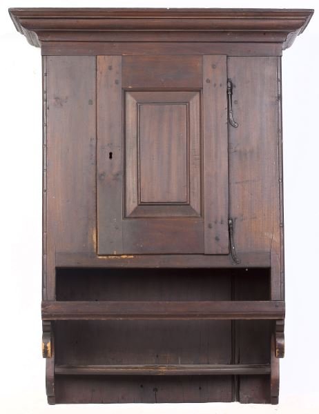American Hanging Cupboard: American Hanging Cupboard circa 1800, probably Pennsylvania, poplar, applied molded cornice, single raised panel door with rat tail hinges, molded cornice and scrolled sides. 37 x 28 x 12 in. Deaccess