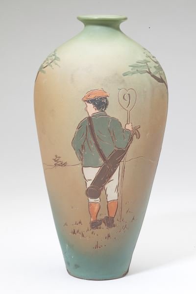 Dickens Ware / Weller Golf Theme Vase, A. Dunlavy: Dickens Ware / Weller Golf Theme Vase, A. Dunlavy circa 1900, Weller Second Line, a tapered vase with incised polychrome decoration on a light green field depicting a caddy on the 9th hole, artist sig