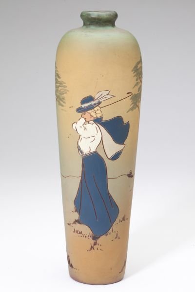 Dickens Ware / Weller Golf Theme Vase: Dickens Ware / Weller Golf Theme Vase circa 1900, Weller Second Line, tall tapered form with incised polychrome decoration on a green and tan field of a lady golfer at play, with impressed Dickens War