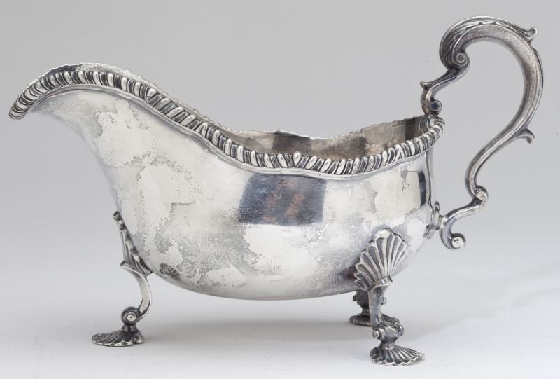 George III Silver Sauce Boat: George III Silver Sauce Boatwith London (1763) hallmarks, illegible maker's mark, inscribed on the underside "No. 10 / 12 Oz. 15 Dwt.," gadrooned applied decoration to rim, raised on three cast and ap