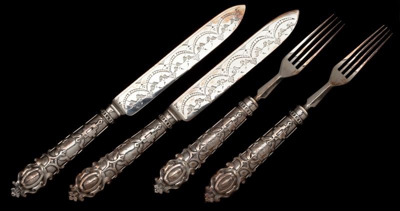 Two Pairs of Victorian Silver Cake Knives & Forks: Two Pairs of Victorian Silver Cake Knives & Forks all four pieces with Sheffield (1862) hallmarks to handles and blades, John Nowell sponsor's mark, the handles in a raised strapwork motif, the knife 