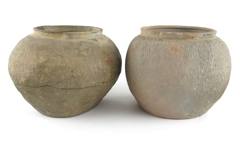 Two Neolithic Vietnamese Ceramic Storage Jars: Two Neolithic Vietnamese Ceramic Storage Jars squat bulbous form with wide mouths, one with combed hatch decoration, the other with impressed diamond shapes. 6.5 in. high