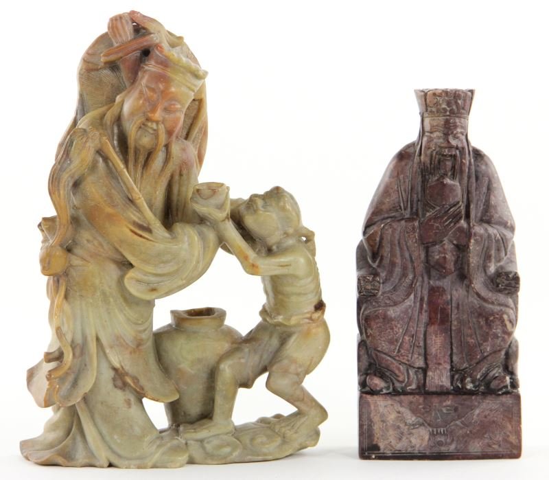 Two Fine Chinese Hardstone Figural Carvings: Two Fine Chinese Hardstone Figural Carvings the first a red stone of an emperor seated on a throne chair covered by a leopard skin, engraved all-over with details, with seal carving to underside (7 in