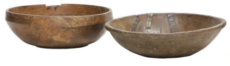 Two Very Large Wooden Dough Bowls: Two Very Large Wooden Dough Bowls19th century, hand carved and planed, the first of footed form (10.5 x 30.25 in.) (with later bottom interior board and hole to the side); the second with rim (9 x 32.