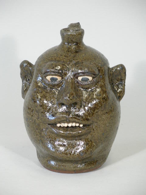 Georgia Folk Pottery Lanier Meaders, Face Jug,: Georgia Folk Pottery Lanier Meaders, Face Jug,alkaline glaze w/good all over color, clay teeth, signed on the bottom in script, 9"h Est. 700-900