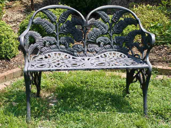 Pair of Richmond Virginia Cast Iron Garden Settees: Pair of Richmond Virginia Cast Iron Garden Settees,black paint w/open fern motif to back, stamped on front seat rail "JAMES W CARR. RICHMOND VA", one settee w/bolts replaced, 29.5"h x 39.5"w x 24"d Es