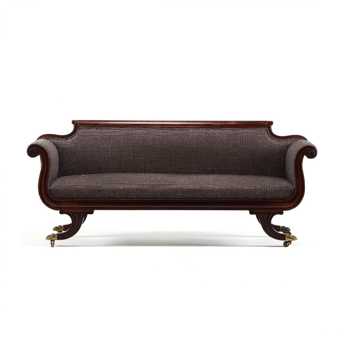 New York Federal Carved Sofa, Shop of Duncan Phyfe: circa 1810-20, mahogany, the crest rail has a pronounced scroll with horizontal panel, rosettes at the end, the molded convex seat rail extends to each scrolled arm with a large rosette terminus, rais