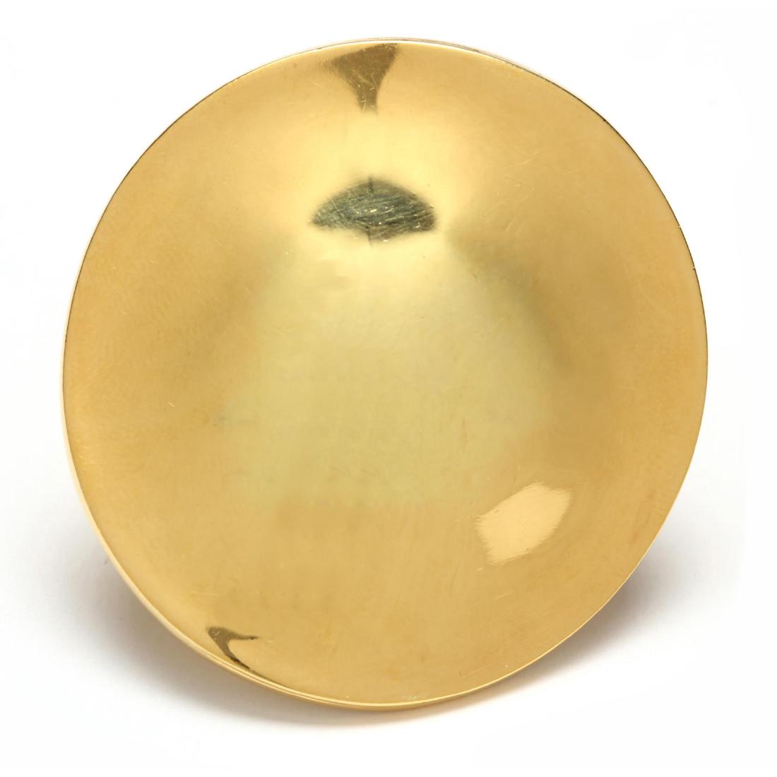18KT Gold Brooch, Robert Lee Morris: circa 1975, the disc form brooch with a raised center and designed in high polish yellow gold, completed with single pin stem, with engraved signature of maker and stamped 18KT. 2 in. diameter 15.0 dw