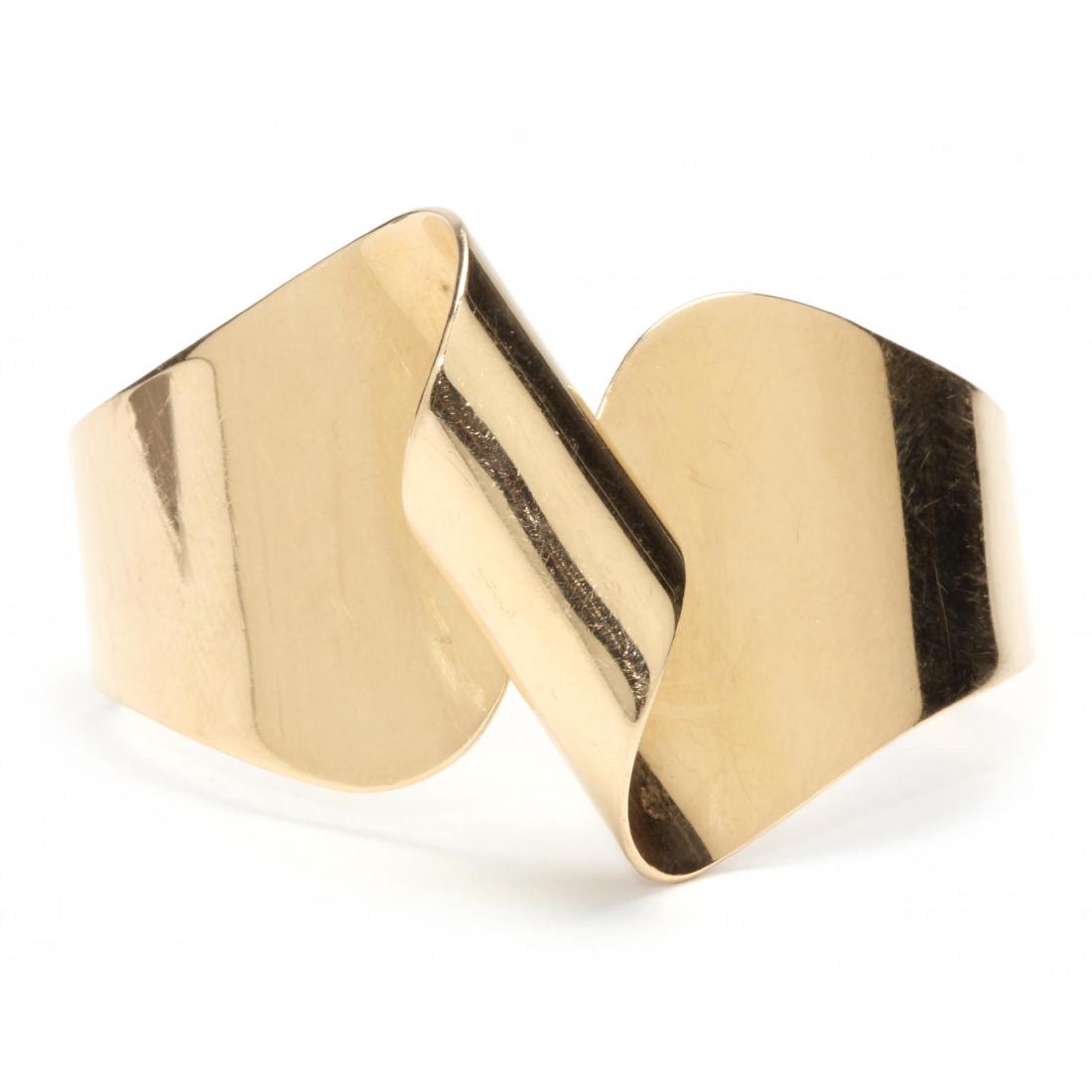 Vintage 14KT Gold Cuff Bracelet: circa 1960, designed in a wide twist form and engraved to the underside "Of all the words from lips or pen / the saddest are these, 'It might have been.'" Stamped 14KT and with a maker's mark. 1.5 x 5