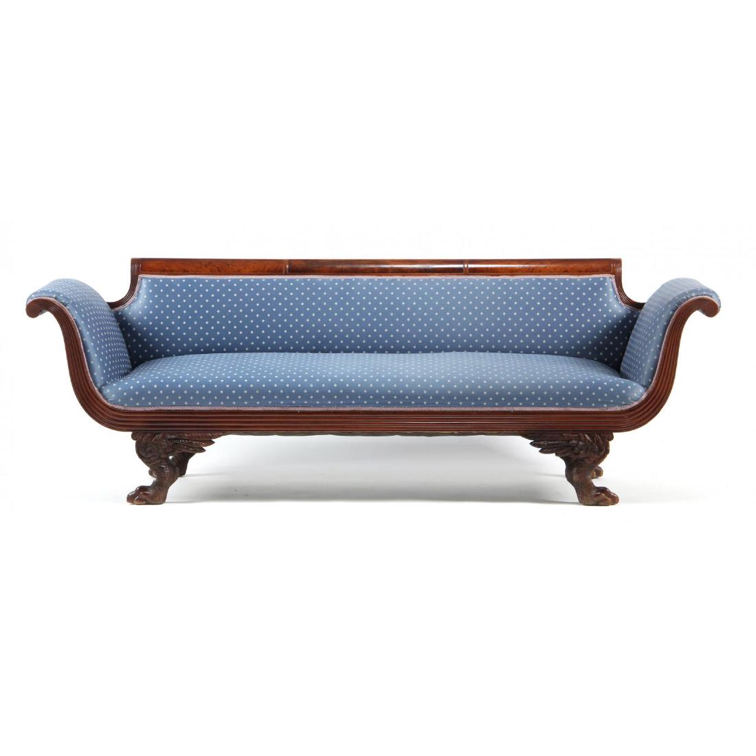 American Late Federal Sofa: New York, attributed to the Duncan Phyfe shop, circa 1820-30, mahogany, mahogany veneer, scrolled crest rail with three inset panels, over upholstered frame having a reeded front skirt rail which cont