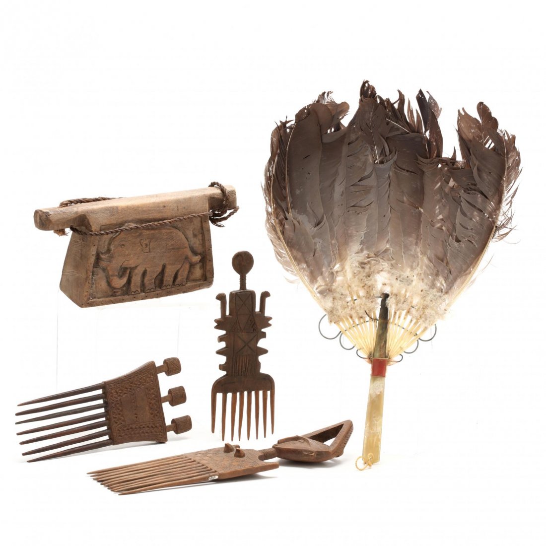 Five West African Decorative Accessories: to include: fan with bone handle (16 in.) (some losses to handle; bends to feathers); carved wooden bell with elephants to sides (9.5 in. LOA) (good condition); three Abron or Ashanti carved wooden co