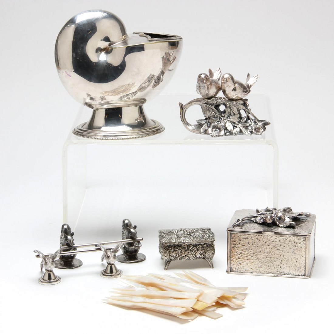 Six Vintage & Antique Silverplate Novelties: including two figural knife rests, a nautilus shell spoon warmer (6.25 in.), (2) decorative boxes, and a birds on branch salt & pepper set.
