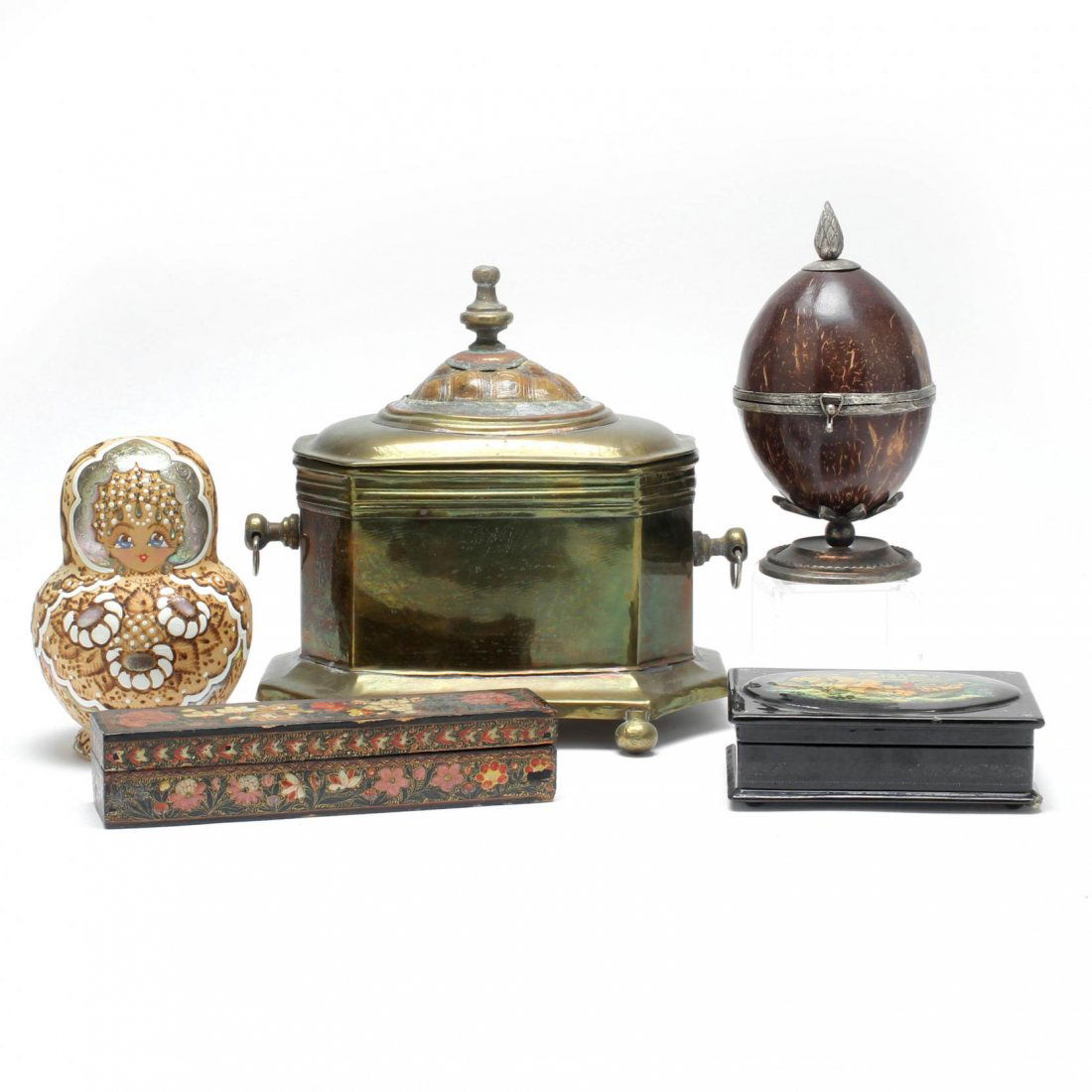 Group of Decorative Boxes: 20th century, including a Russian painted box, brass box, coconut box, a matryoshka nesting doll, and a tramp art style box. Tallest 10 in.