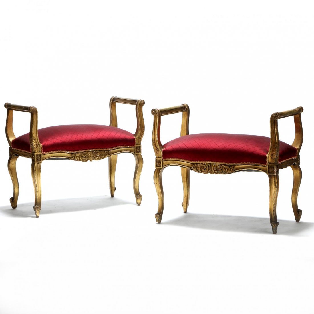 A Pair Louis XV Style Window Seats: late 19th century, having gilded and carved frames which are relief decorated with acanthus leaves and rosettes, seats with later silk upholstery and braided trim. 26 x 31 x 16 in. Randall Tysinger An